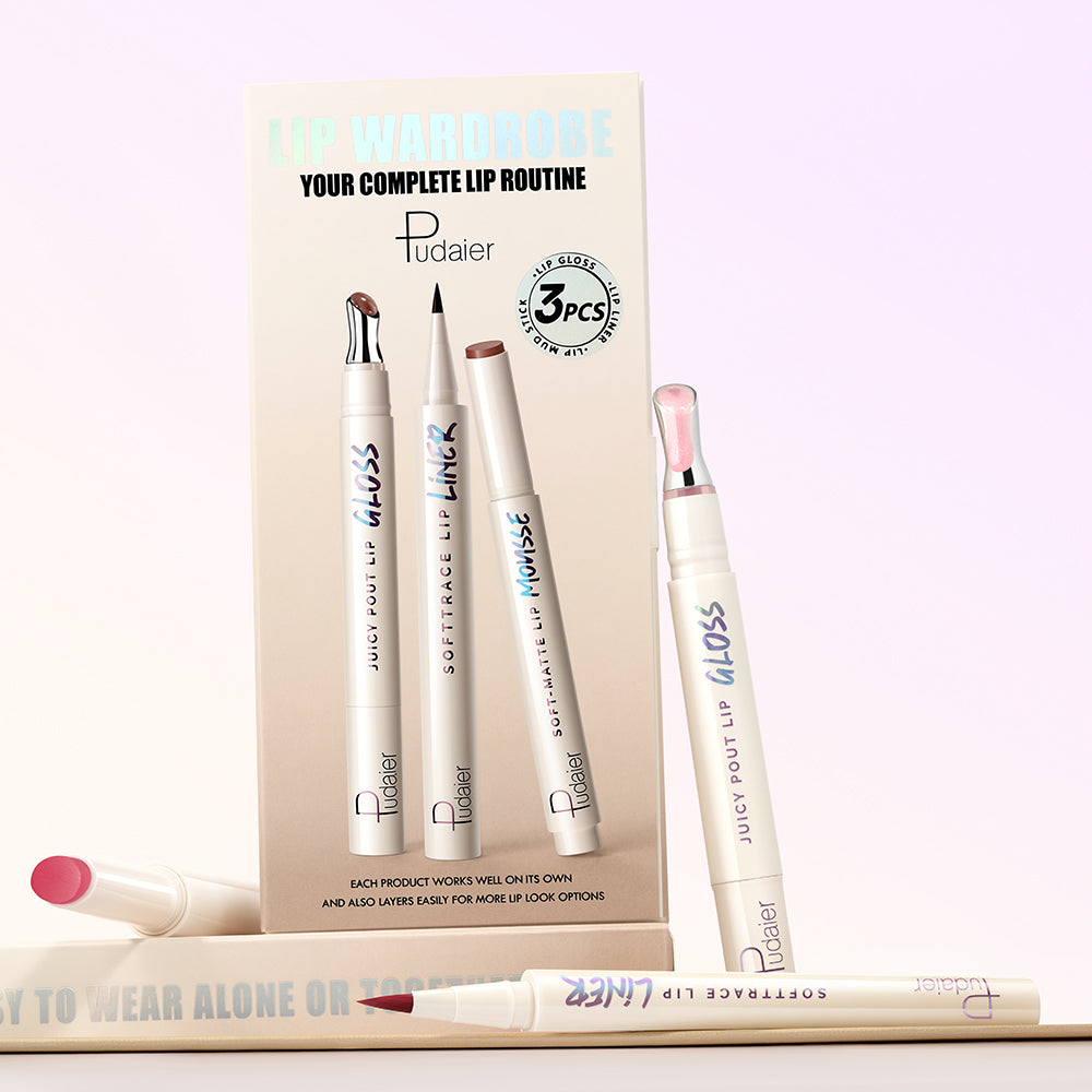 Three lip products arranged with shade smears on white surface